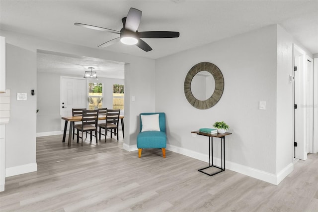 6804 Tierra Verde St, Port Richey, FL 34668 - sitting room featuring wood finished floors, a ceiling fan, and baseboards