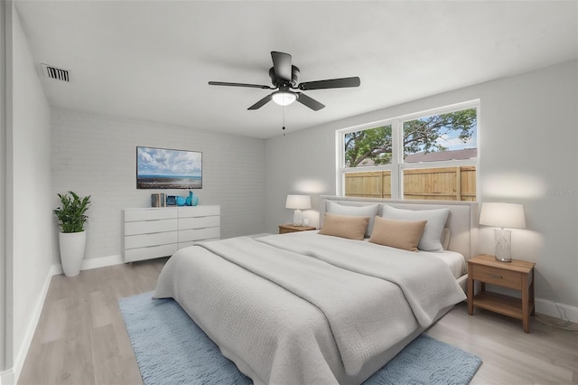 6804 Tierra Verde St, Port Richey, FL 34668 - bedroom with baseboards, light wood-style flooring, and ceiling fan