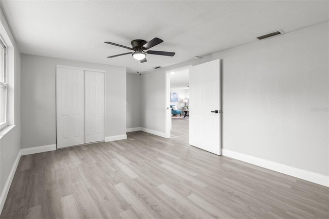 6804 Tierra Verde St, Port Richey, FL 34668 - unfurnished bedroom featuring light wood-style floors, baseboards, and a closet
