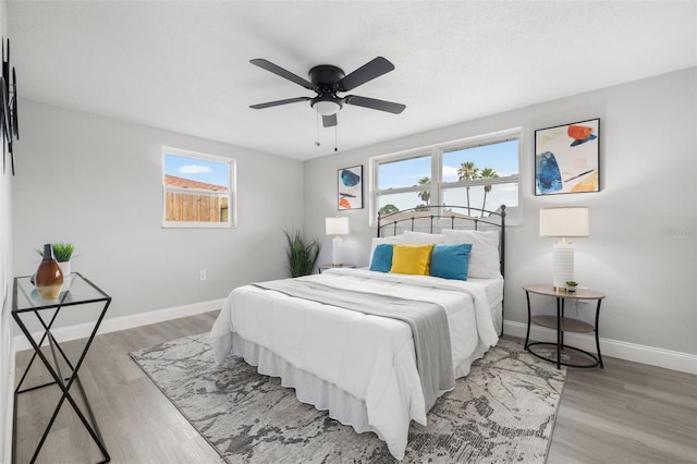 6804 Tierra Verde St, Port Richey, FL 34668 - bedroom featuring baseboards, wood finished floors, and a ceiling fan