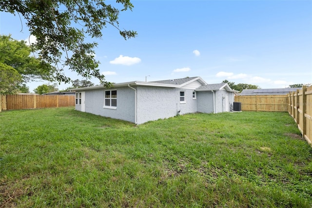 6804 Tierra Verde St, Port Richey, FL 34668 - rear view of property featuring central air condition unit and stucco siding