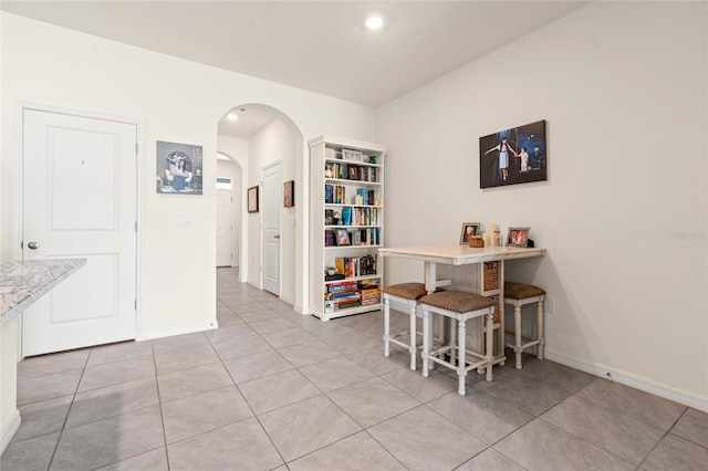 2925 Evergreen Elm Pass, Wesley Chapel, FL 33543 - dining area featuring arched walkways, baseboards, light tile patterned flooring, and recessed lighting