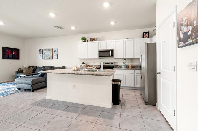 2925 Evergreen Elm Pass, Wesley Chapel, FL 33543 - kitchen with stainless steel appliances, open floor plan, light stone countertops, white cabinetry, and recessed lighting
