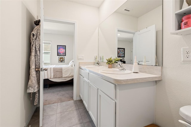 2925 Evergreen Elm Pass, Wesley Chapel, FL 33543 - full bath with double vanity, connected bathroom, tile patterned floors, and toilet