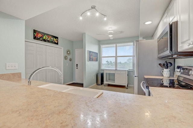 960 Starkey Rd Unit 2405, Largo, FL 33771 - kitchen with stainless steel appliances, a sink, light tile patterned floors, white cabinetry, and light countertops