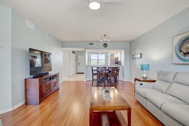 960 Starkey Rd Unit 2405, Largo, FL 33771 - living area with light wood-style floors, a ceiling fan, and baseboards