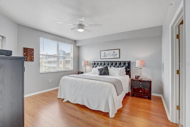 960 Starkey Rd Unit 2405, Largo, FL 33771 - bedroom with light wood finished floors, a textured ceiling, baseboards, and ceiling fan
