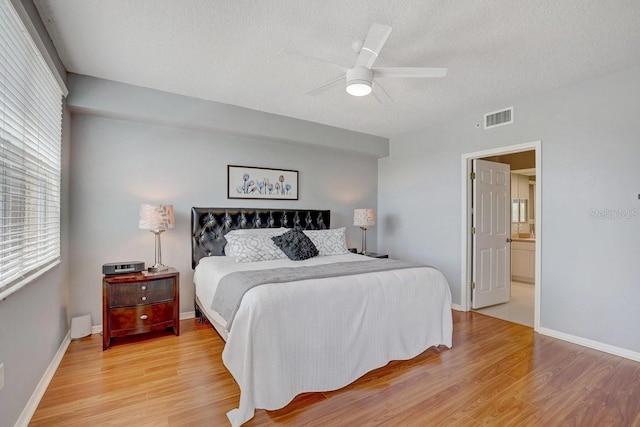 960 Starkey Rd Unit 2405, Largo, FL 33771 - bedroom with a textured ceiling, light wood-style floors, a ceiling fan, and baseboards
