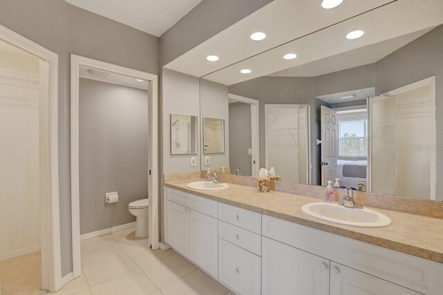 960 Starkey Rd Unit 2405, Largo, FL 33771 - full bathroom with a walk in closet, toilet, double vanity, tile patterned floors, and recessed lighting