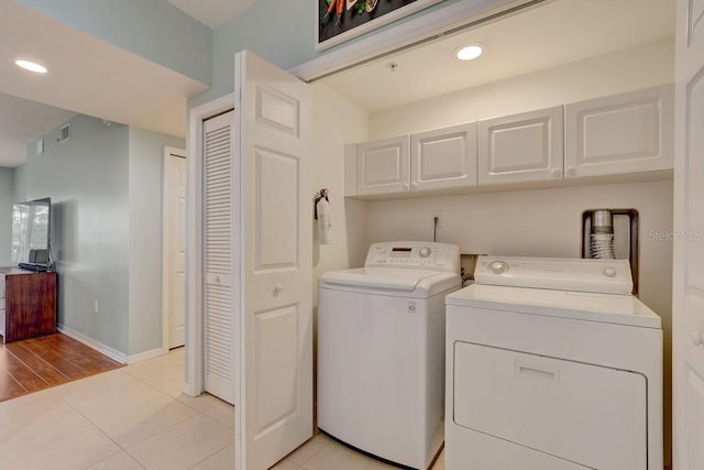 960 Starkey Rd Unit 2405, Largo, FL 33771 - washroom with washer and clothes dryer, cabinet space, baseboards, light tile patterned floors, and recessed lighting