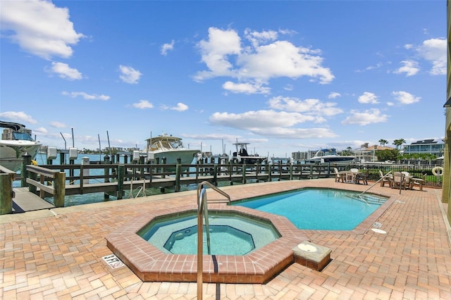200 Skiff Pt Unit 202, Clearwater Beach, FL 33767 - community pool featuring a community hot tub, boat lift, a dock, and a patio area