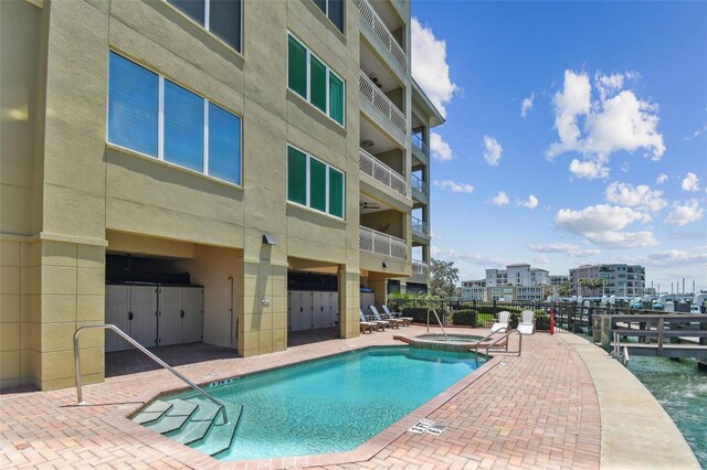 200 Skiff Pt Unit 202, Clearwater Beach, FL 33767 - view of swimming pool featuring a patio area and a pool with connected hot tub