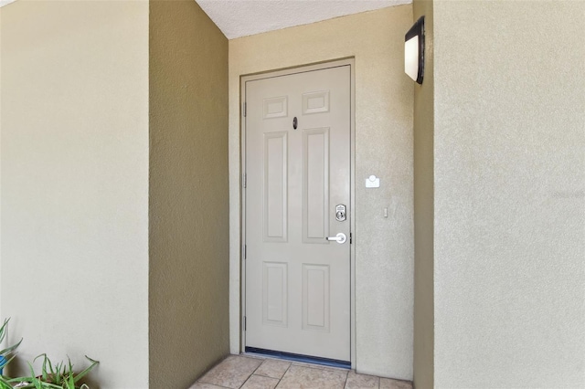 200 Skiff Pt Unit 202, Clearwater Beach, FL 33767 - view of exterior entry featuring stucco siding