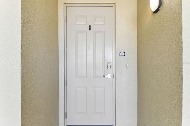 200 Skiff Pt Unit 202, Clearwater Beach, FL 33767 - doorway to property with stucco siding