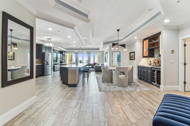 200 Skiff Pt Unit 202, Clearwater Beach, FL 33767 - dining space with a raised ceiling, wine cooler, light wood finished floors, crown molding, and bar