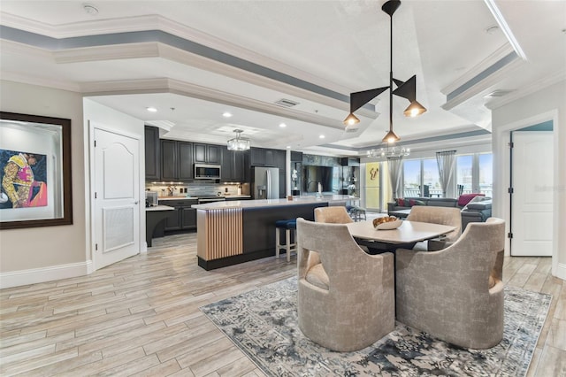 200 Skiff Pt Unit 202, Clearwater Beach, FL 33767 - dining space featuring a chandelier, ornamental molding, light wood-style floors, and baseboards