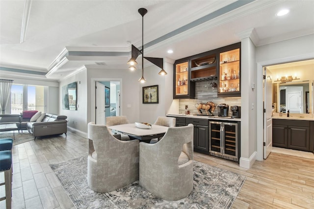200 Skiff Pt Unit 202, Clearwater Beach, FL 33767 - dining room with wine cooler, bar with sink, ornamental molding, light wood-style floors, and recessed lighting