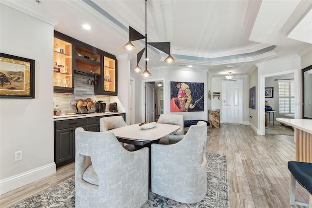 200 Skiff Pt Unit 202, Clearwater Beach, FL 33767 - dining space with wet bar, ornamental molding, light wood finished floors, baseboards, and recessed lighting
