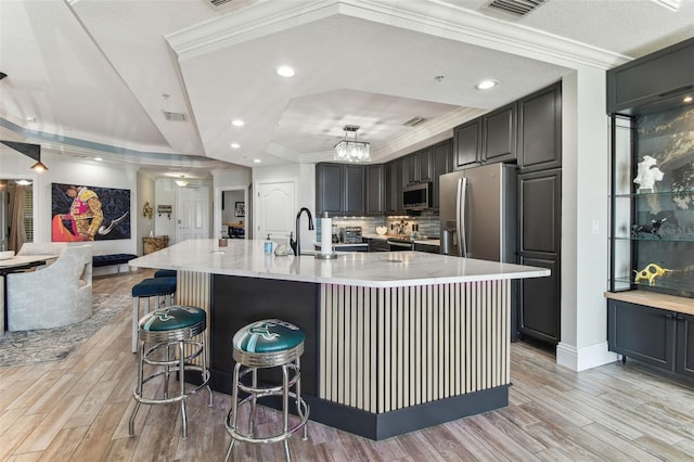 200 Skiff Pt Unit 202, Clearwater Beach, FL 33767 - kitchen with stainless steel appliances, open floor plan, a sink, light wood-type flooring, and recessed lighting