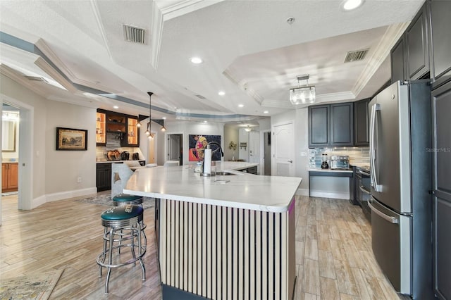 200 Skiff Pt Unit 202, Clearwater Beach, FL 33767 - kitchen featuring freestanding refrigerator, a sink, recessed lighting, tasteful backsplash, and ornamental molding