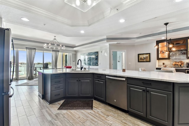 200 Skiff Pt Unit 202, Clearwater Beach, FL 33767 - kitchen featuring appliances with stainless steel finishes, a raised ceiling, a sink, decorative backsplash, and recessed lighting