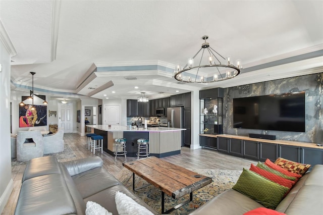 200 Skiff Pt Unit 202, Clearwater Beach, FL 33767 - living area with a chandelier, ornamental molding, baseboards, light wood-style floors, and recessed lighting