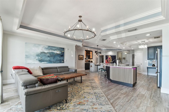 200 Skiff Pt Unit 202, Clearwater Beach, FL 33767 - living area with a chandelier, crown molding, baseboards, light wood-type flooring, and recessed lighting