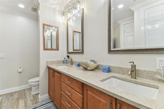 200 Skiff Pt Unit 202, Clearwater Beach, FL 33767 - full bath featuring toilet, double vanity, crown molding, baseboards, and wood finished floors