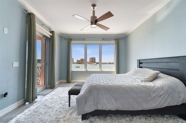200 Skiff Pt Unit 202, Clearwater Beach, FL 33767 - bedroom with crown molding, wood finished floors, baseboards, and a water view