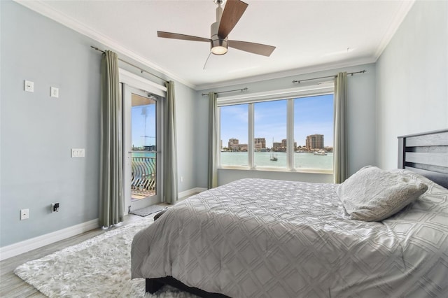 200 Skiff Pt Unit 202, Clearwater Beach, FL 33767 - bedroom with access to exterior, baseboards, wood finished floors, crown molding, and ceiling fan
