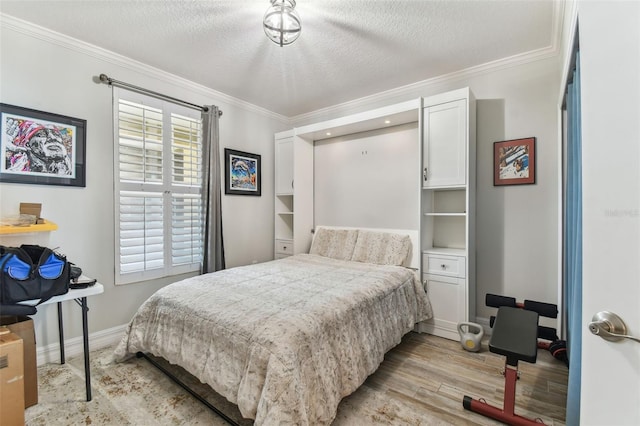 200 Skiff Pt Unit 202, Clearwater Beach, FL 33767 - bedroom featuring light wood-style flooring, ornamental molding, baseboards, and a textured ceiling