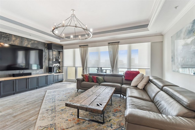 200 Skiff Pt Unit 202, Clearwater Beach, FL 33767 - living area featuring a chandelier, a tray ceiling, light wood-type flooring, and crown molding
