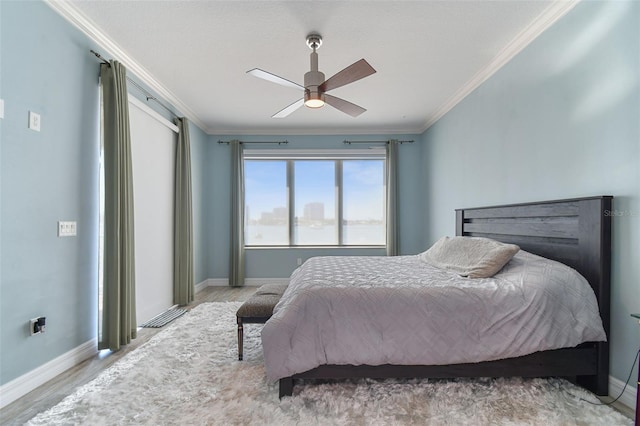 200 Skiff Pt Unit 202, Clearwater Beach, FL 33767 - bedroom with wood finished floors, baseboards, ornamental molding, and ceiling fan