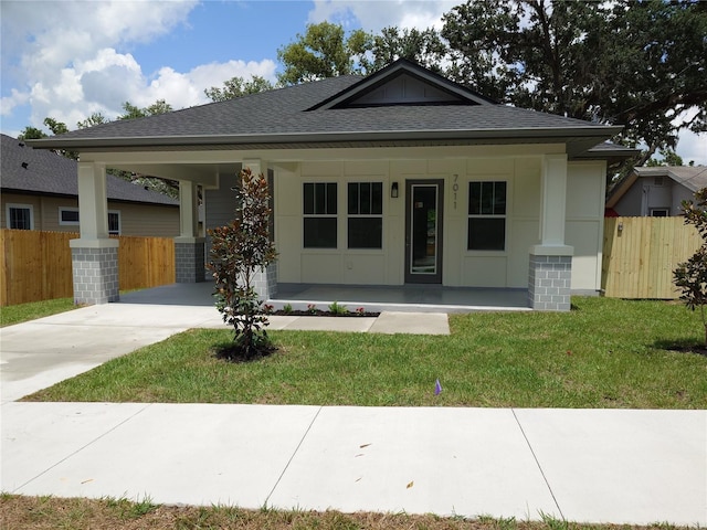 7011 N 15th St, Tampa, FL 33610 - view of front of house featuring a porch, driveway, and roof with shingles