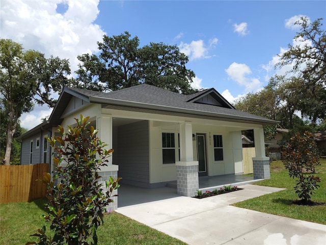7011 N 15th St, Tampa, FL 33610 - bungalow featuring a shingled roof, covered porch, and driveway