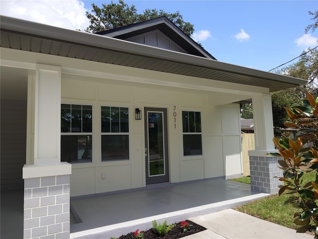 7011 N 15th St, Tampa, FL 33610 - view of exterior entry with board and batten siding and covered porch