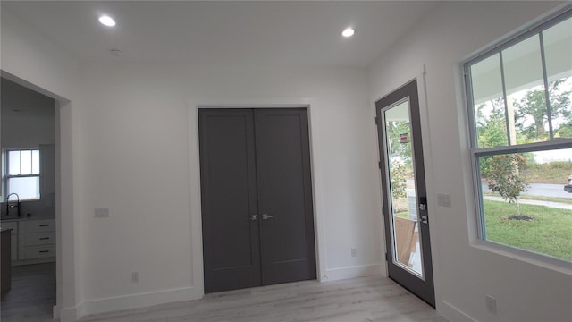 7011 N 15th St, Tampa, FL 33610 - unfurnished bedroom with light wood-style floors, baseboards, recessed lighting, and a sink