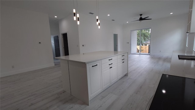 7011 N 15th St, Tampa, FL 33610 - kitchen featuring open floor plan, light wood-style floors, ceiling fan, white cabinets, and recessed lighting