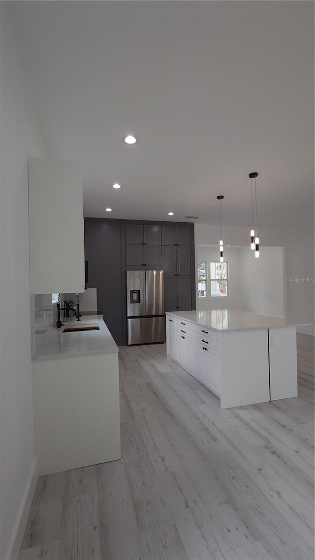 7011 N 15th St, Tampa, FL 33610 - kitchen with stainless steel fridge with ice dispenser, recessed lighting, light countertops, a sink, and baseboards