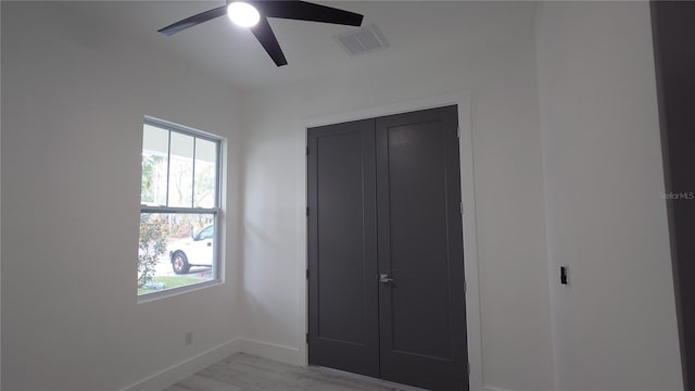 7011 N 15th St, Tampa, FL 33610 - unfurnished bedroom featuring baseboards, light wood finished floors, a ceiling fan, and a closet