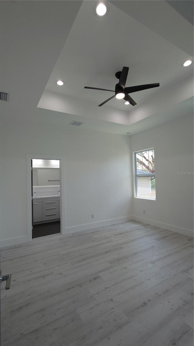 7011 N 15th St, Tampa, FL 33610 - empty room with a tray ceiling, baseboards, light wood-style floors, and recessed lighting