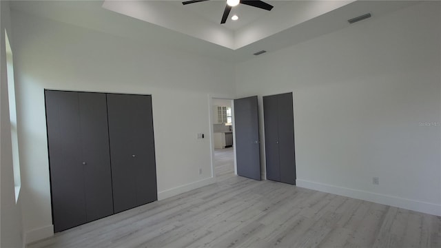 7011 N 15th St, Tampa, FL 33610 - unfurnished bedroom with light wood-type flooring, baseboards, a towering ceiling, a ceiling fan, and recessed lighting