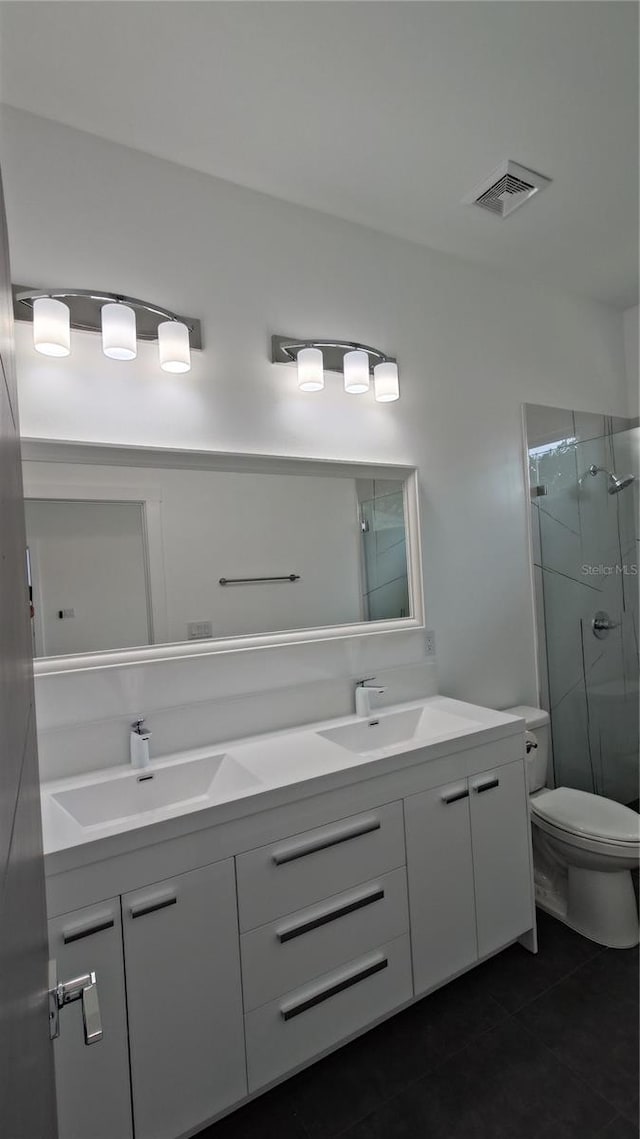 7011 N 15th St, Tampa, FL 33610 - bathroom featuring double vanity, a stall shower, tile patterned floors, and toilet