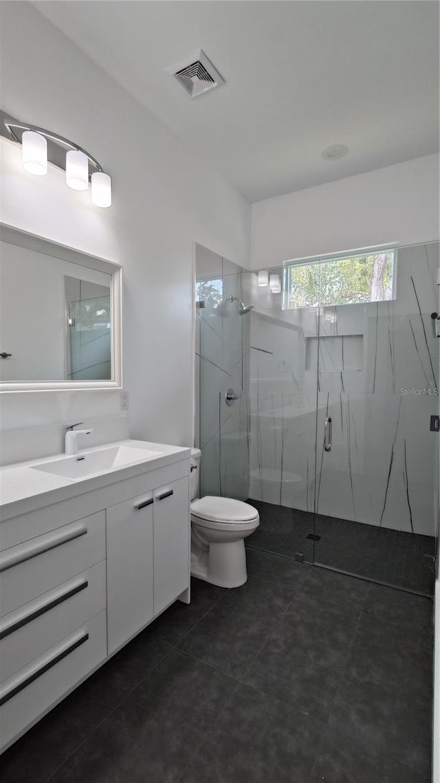 7011 N 15th St, Tampa, FL 33610 - full bath with a marble finish shower, vanity, toilet, and tile patterned floors