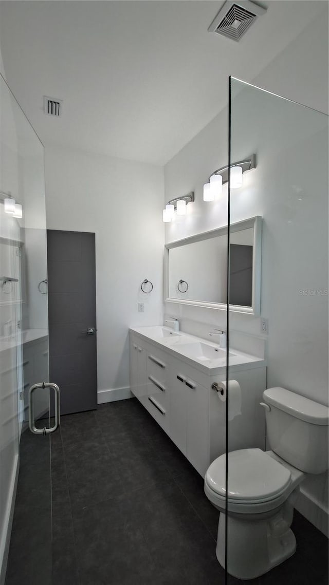 7011 N 15th St, Tampa, FL 33610 - full bath with toilet, double vanity, baseboards, and a shower with door