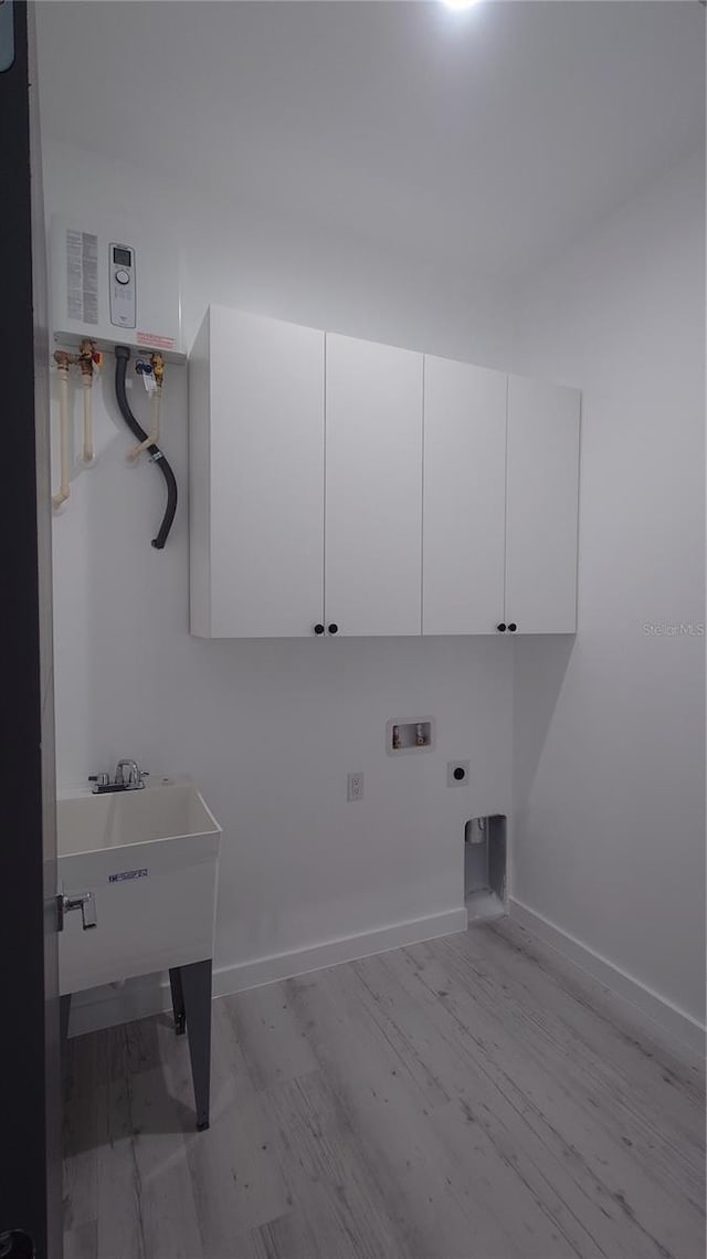 7011 N 15th St, Tampa, FL 33610 - laundry area with washer hookup, cabinet space, hookup for an electric dryer, wood finished floors, and baseboards
