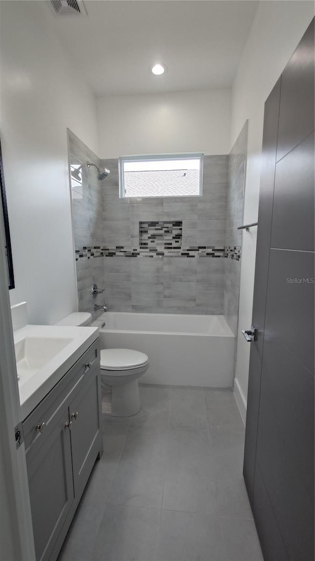 7011 N 15th St, Tampa, FL 33610 - full bathroom featuring vanity, toilet, washtub / shower combination, and tile patterned flooring