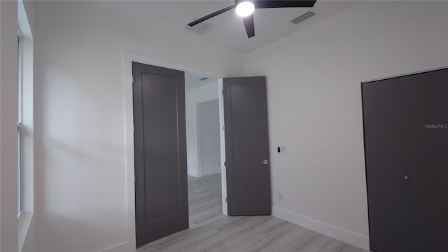 7011 N 15th St, Tampa, FL 33610 - unfurnished bedroom featuring light wood-style flooring, a ceiling fan, and baseboards