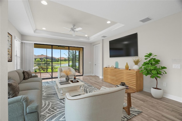 11354 Callisia Dr, Odessa, FL 33556 - living area featuring baseboards, a tray ceiling, light wood-style flooring, ceiling fan, and recessed lighting