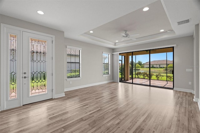 11354 Callisia Dr, Odessa, FL 33556 - empty room with a raised ceiling, baseboards, light wood-style flooring, recessed lighting, and a ceiling fan